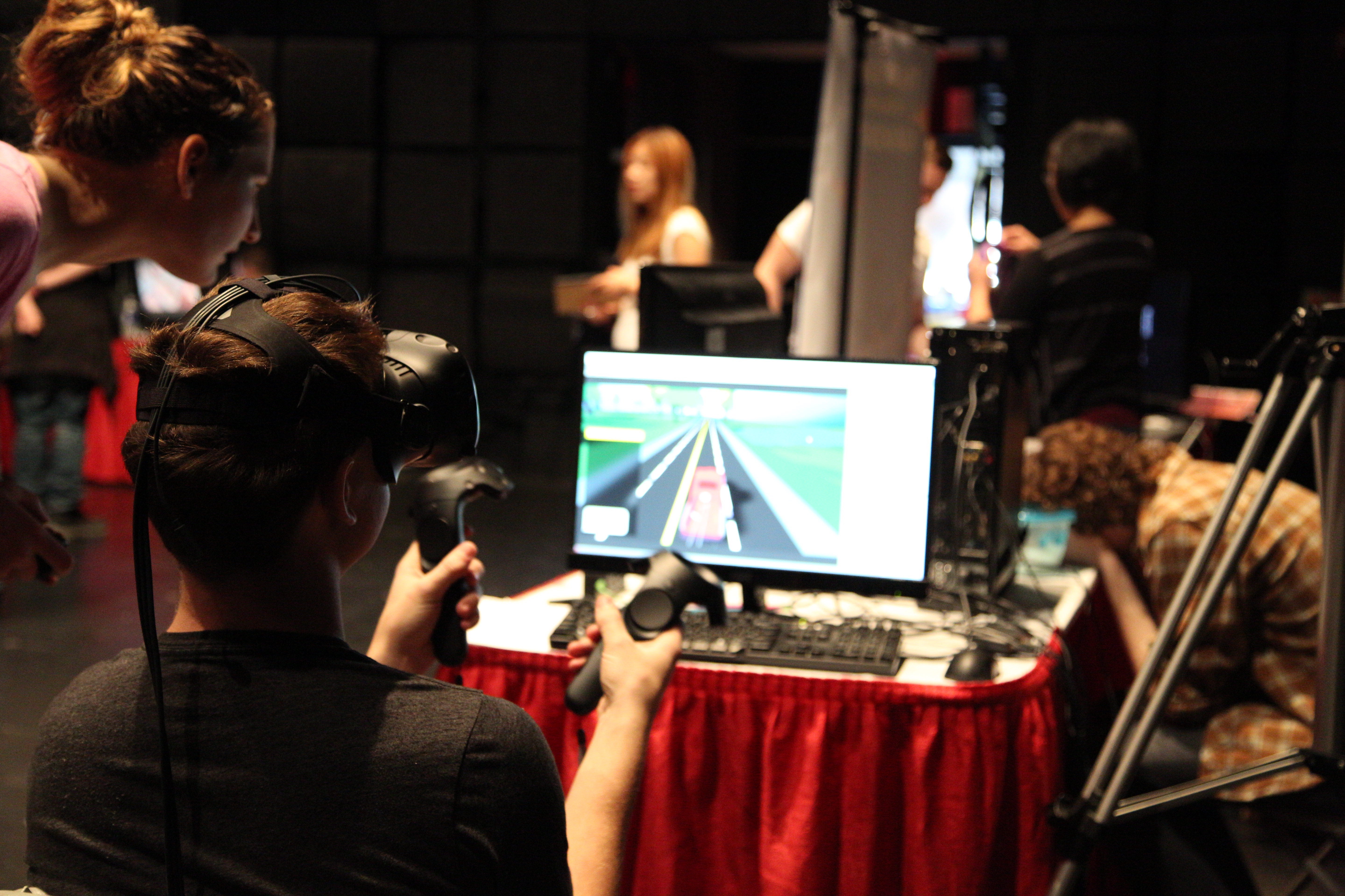 A student playing a VR-style game at GameFest 2016.