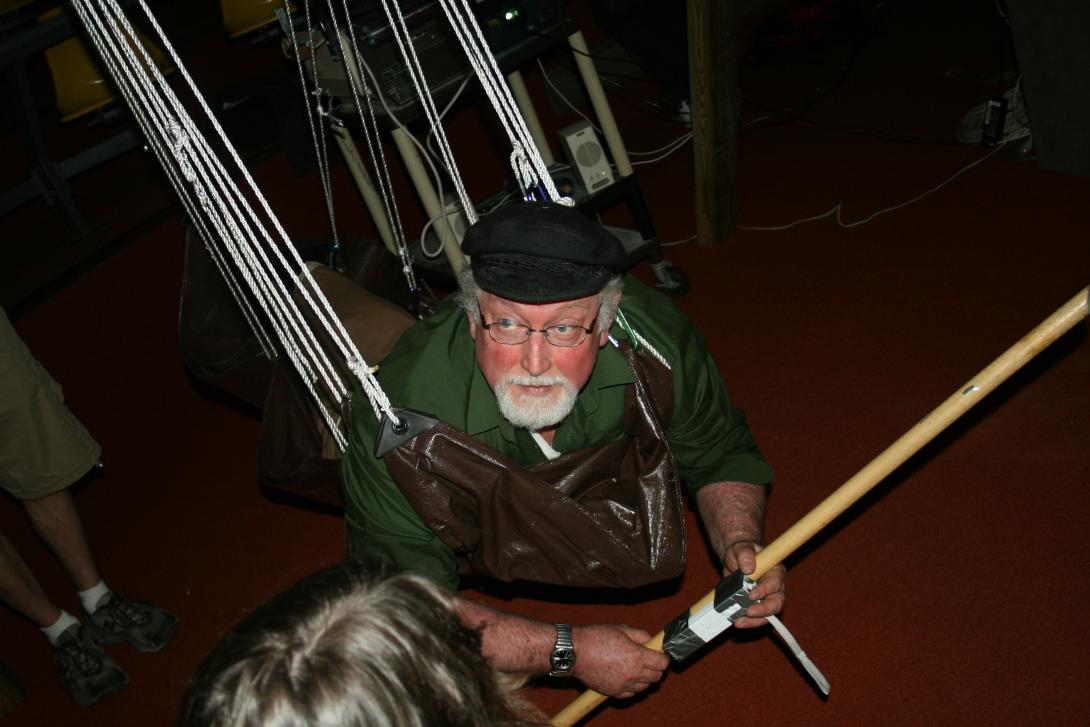 Ralph Noble suspended from a wooden frame at GameFest 2008.